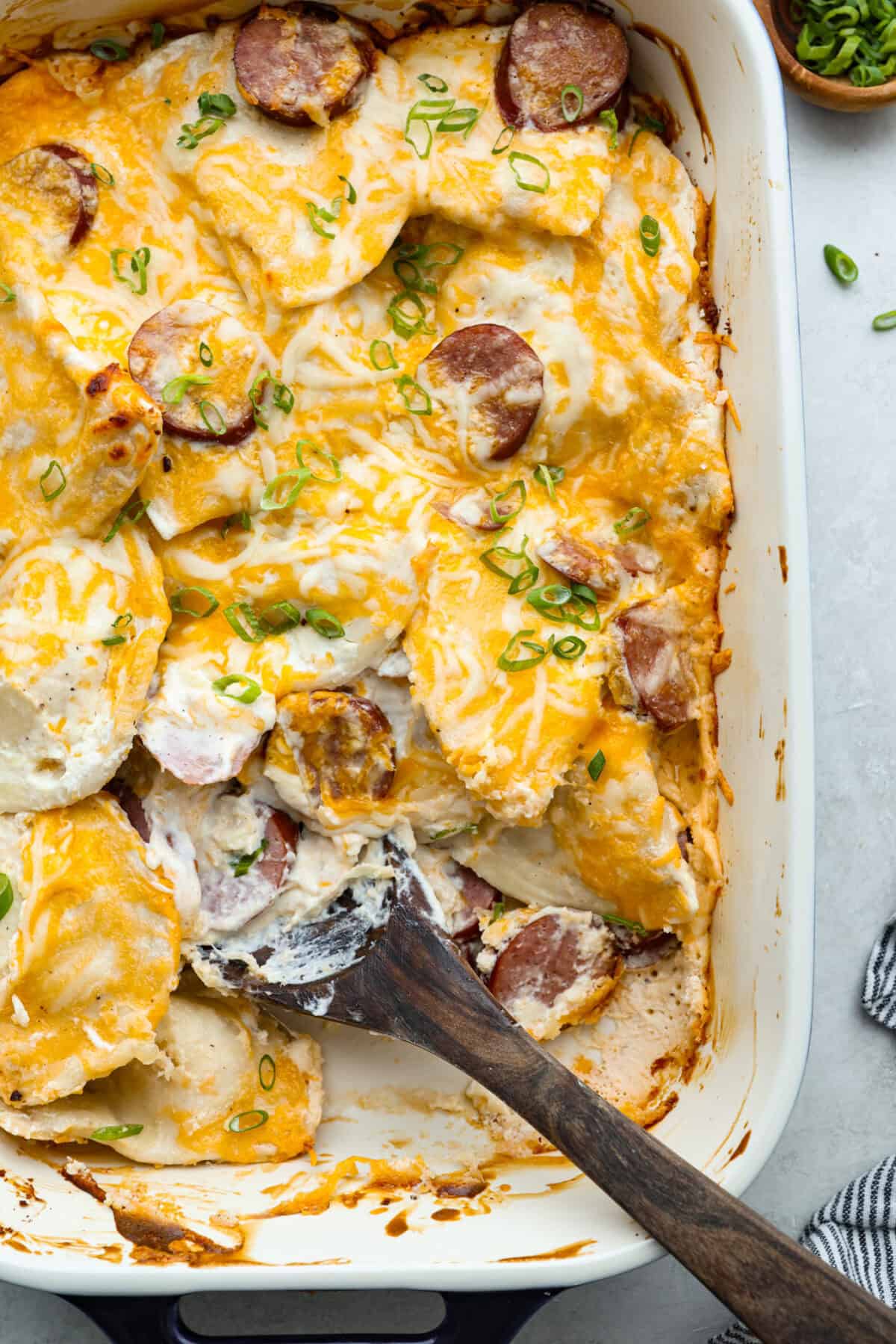 Overhead shot of cheesy pierogi casserole in baking dish. 