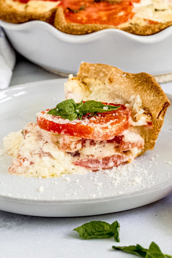 Slice of tomato pie on a white dish