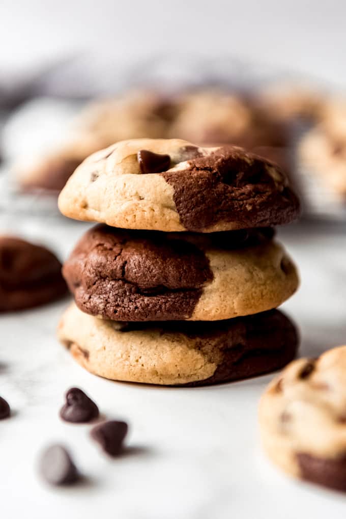 A stack of three chocolate and chocolate chip cookies.
