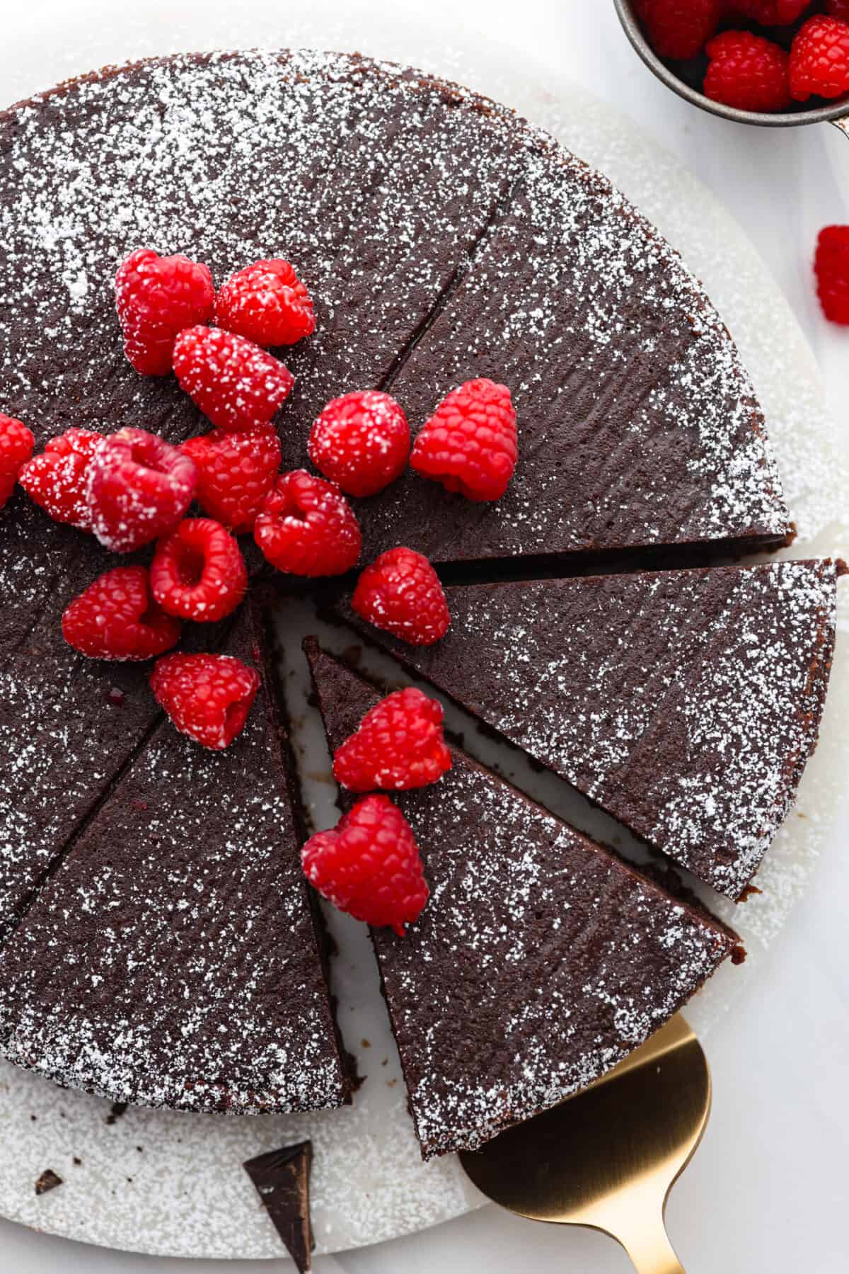 Top-down view of flourless chocolate cake cut into slices.