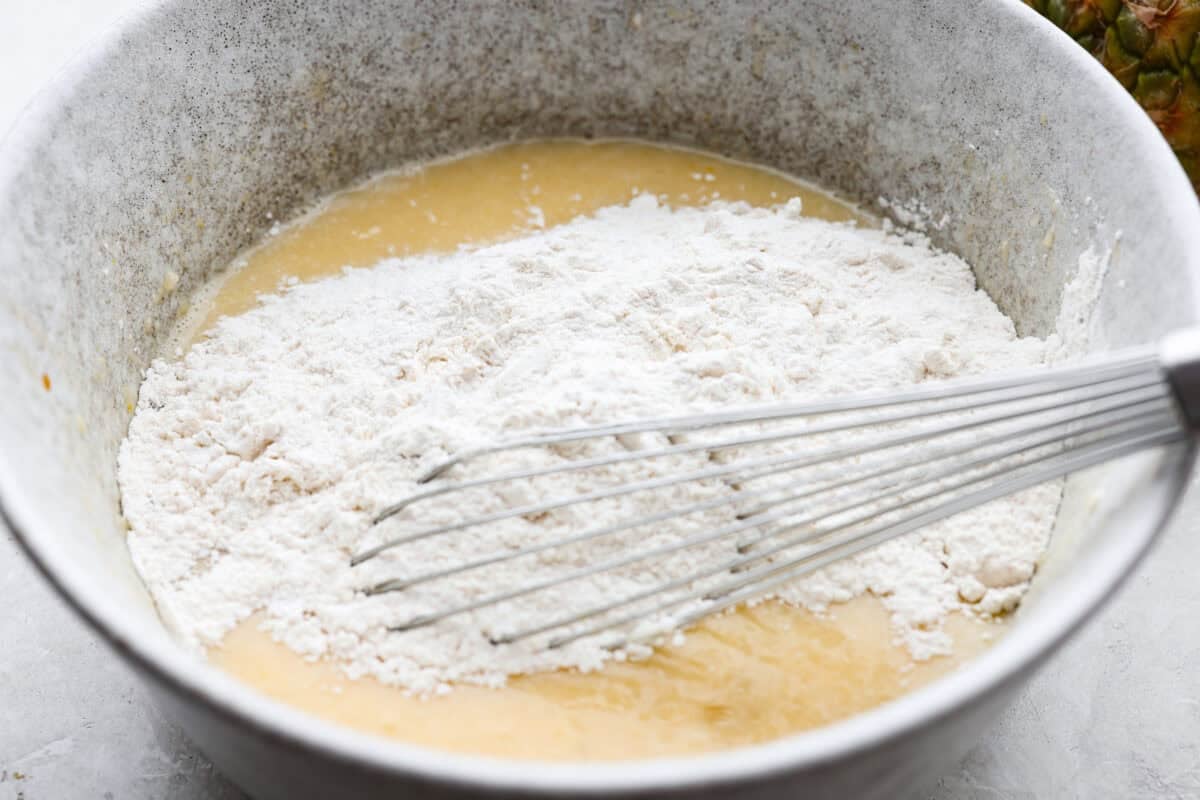 Someone whisking the dry and wet ingredients together. 