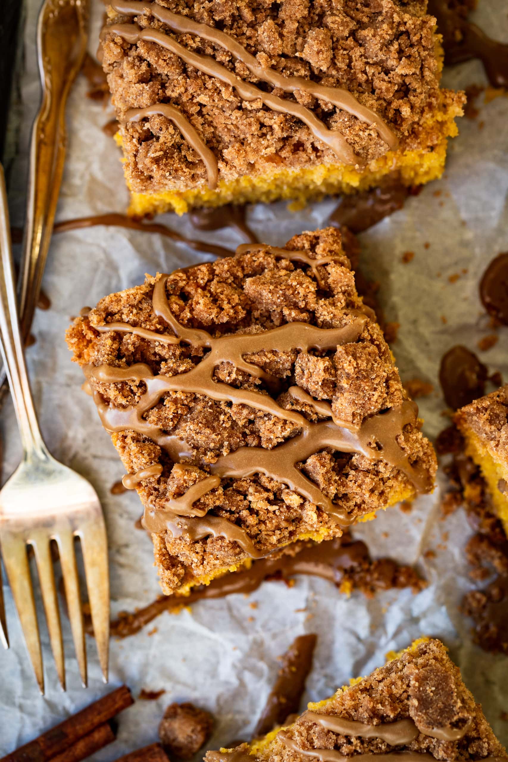 a photo of a single piece of coffee cake taken from above the cake. The coffee cake is topped with cinnamon crumb topping and maple glaze.