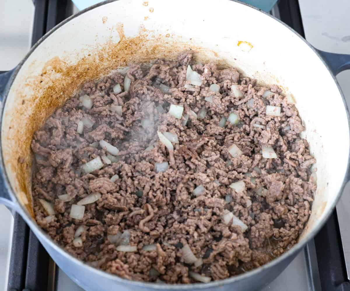 Ground beef and onions cooking in a pot. 