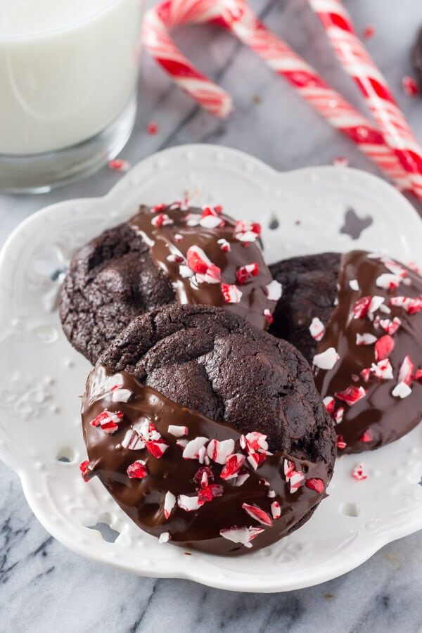 Peppermint Double Chocolate Cookies have a rich chocolate taste and are infused with peppermint. They're dipped in chocolate and sprinkled with crushed candy canes for the perfect holiday cookie!