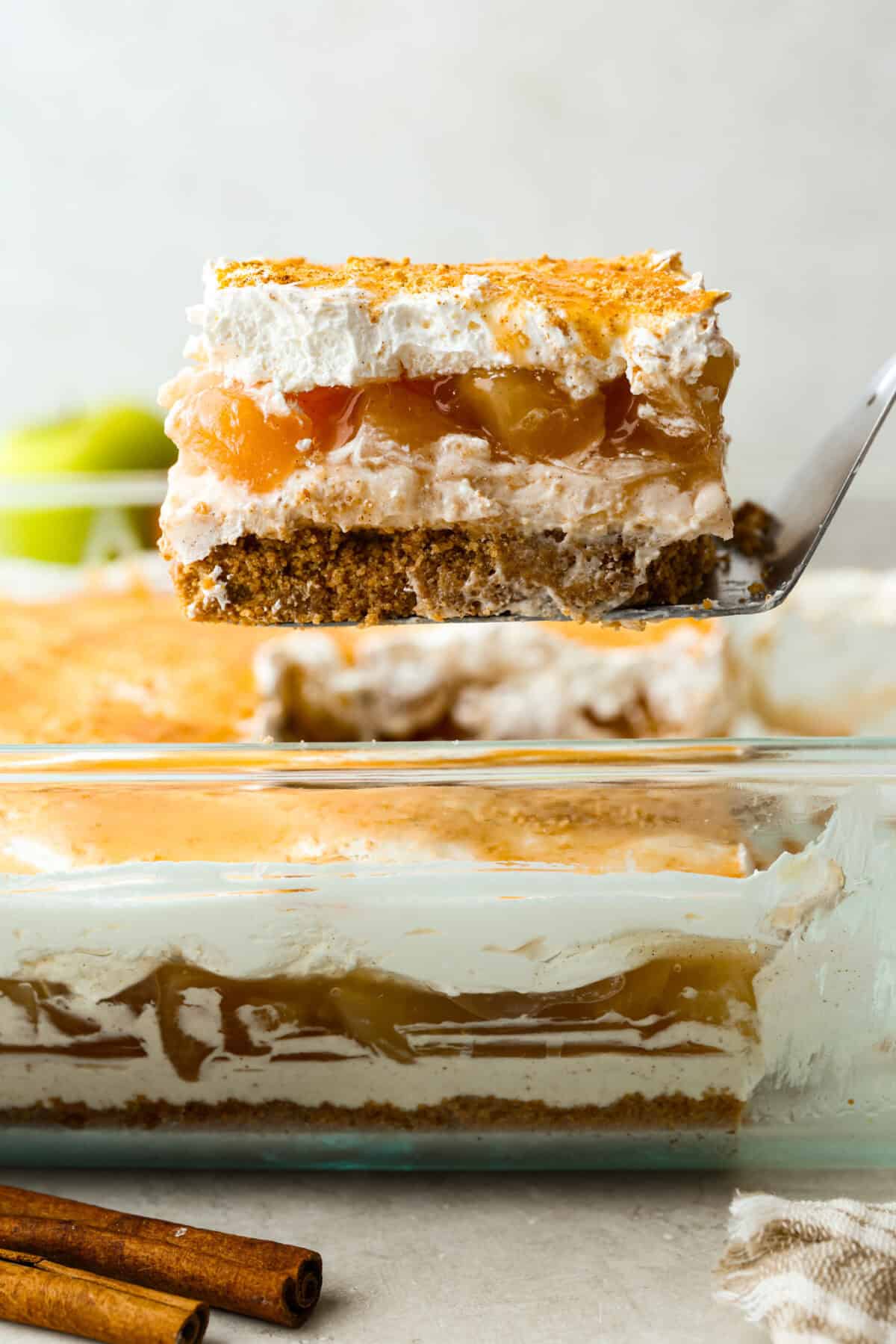 Slice of caramel apple pie lush being lifted out of the pan. 