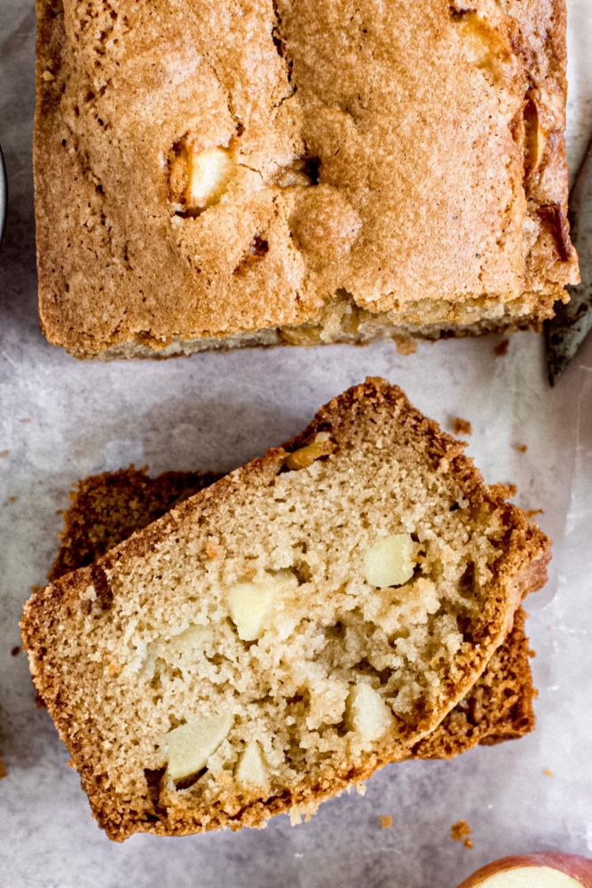 Slices of apple bread next to loaf.