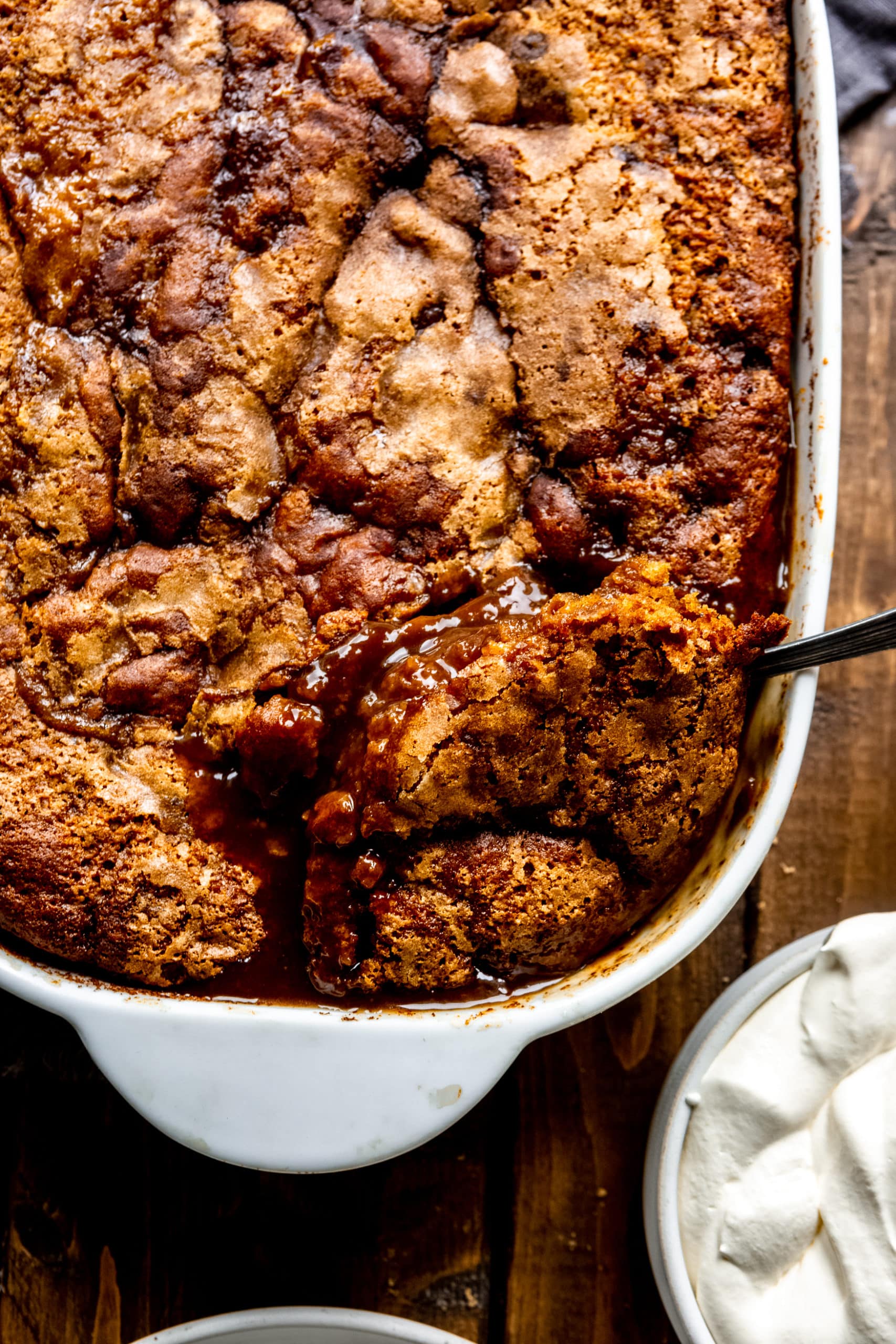 a photo of a serving being removed from a warm baked pumpkin lava cake.