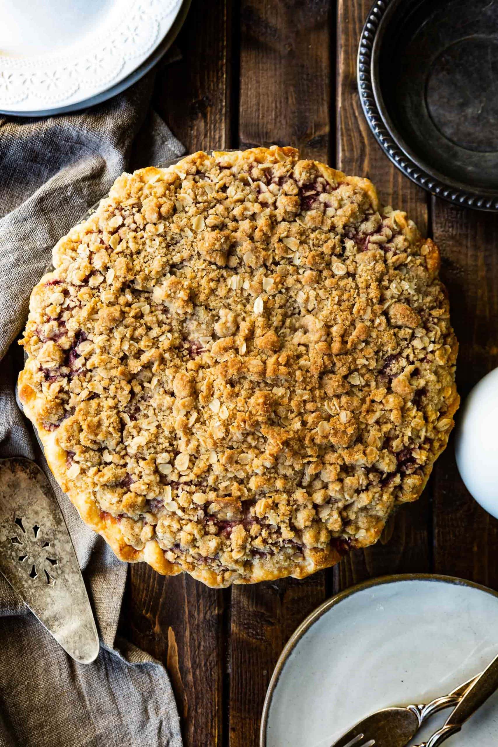 a photo of a whole dutch berry pie topped with golden streusel on top taken from directly over the top of the pie.