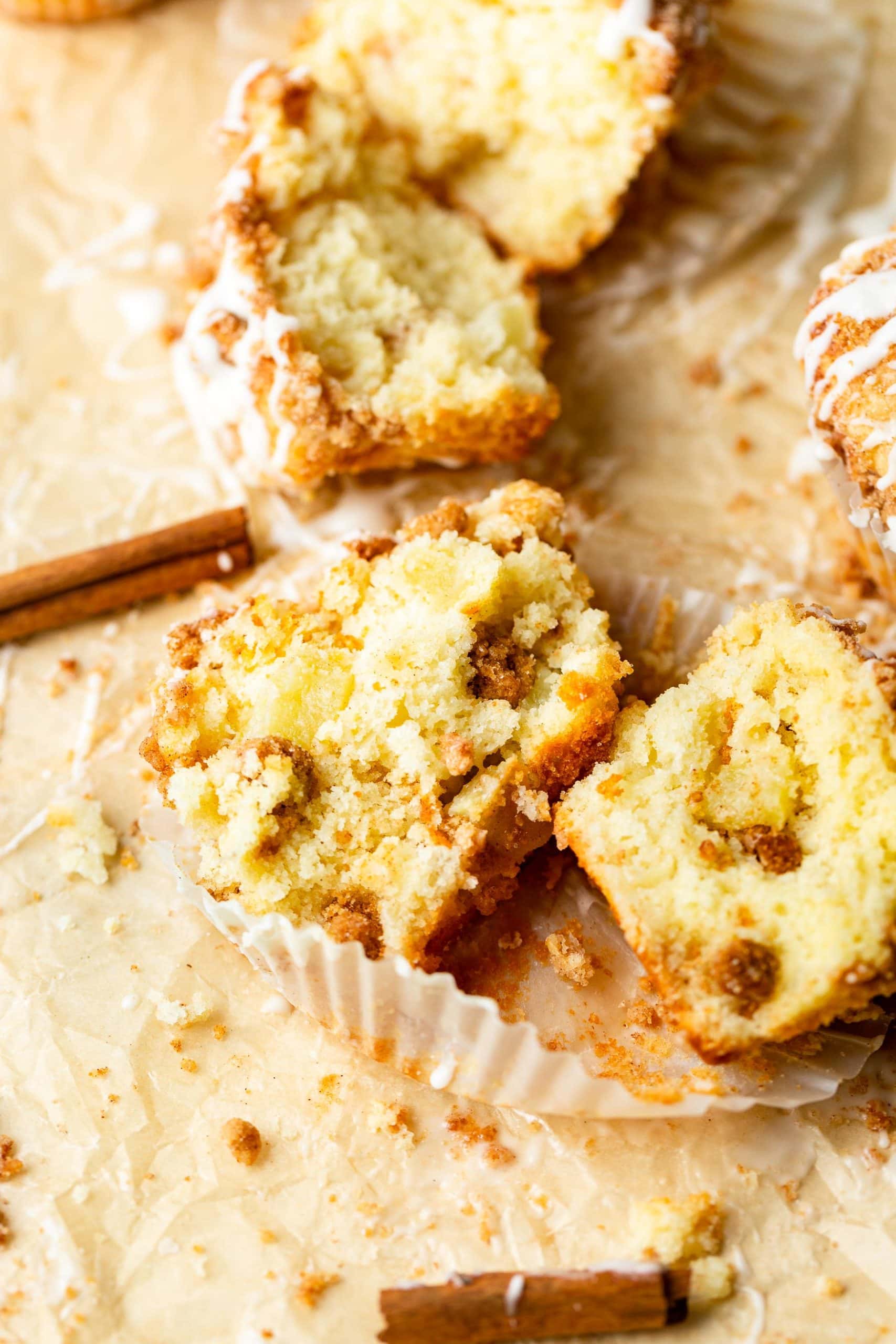 an apple coffee cake muffin loaded with streusel that has been cut open 