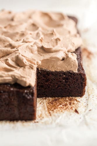 whole chocolate zucchini cake with a piece cut out