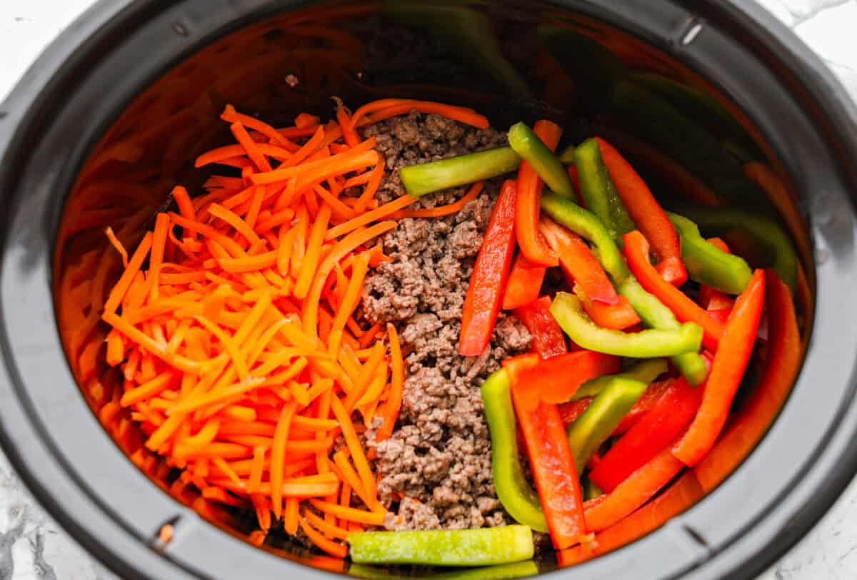 Veggies and beef added to the crock pot. 
