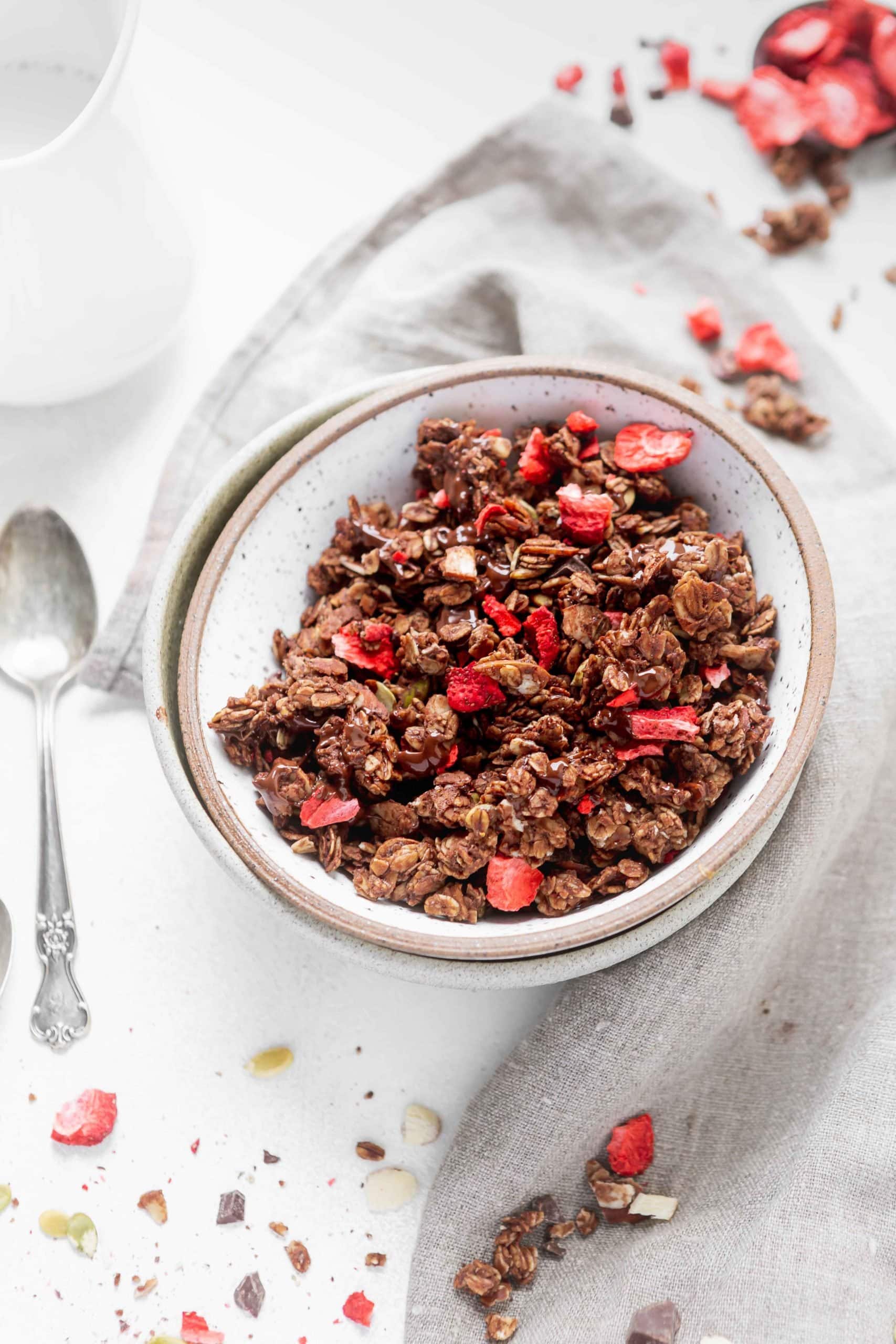 A bowl of chocolate lovers granola with strawberries.