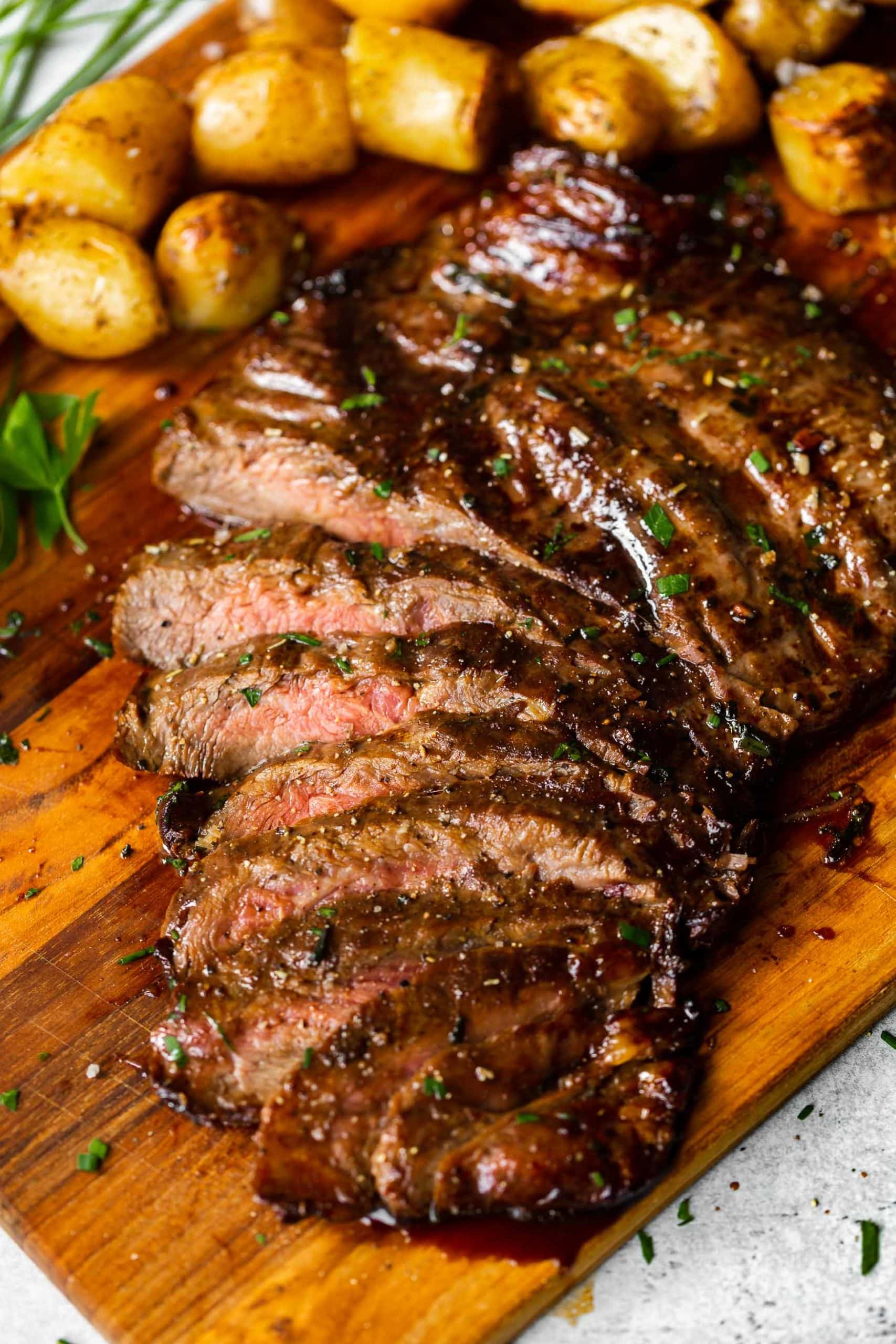 a sliced flank steak that has been cooked on a gas grill with a balsamic soy sauce marinade
