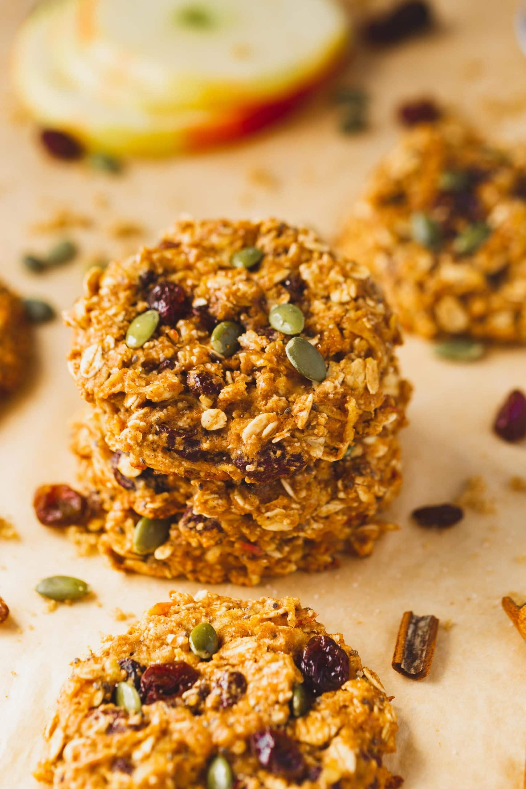 a photo of two healthy breakfast cookies stacked on each other full of raisins and pepitas