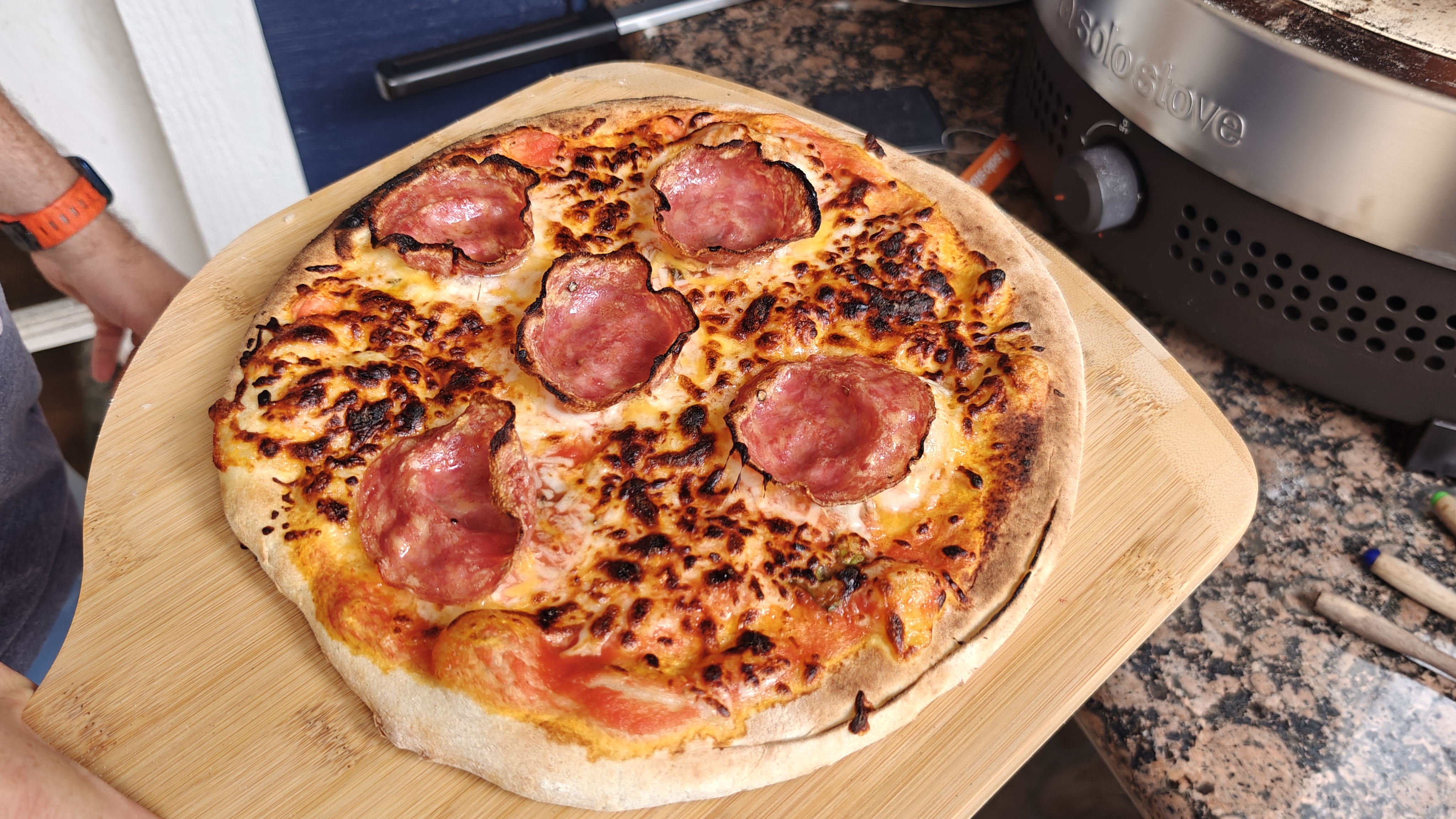 Solo Stove next to a cooked pizza