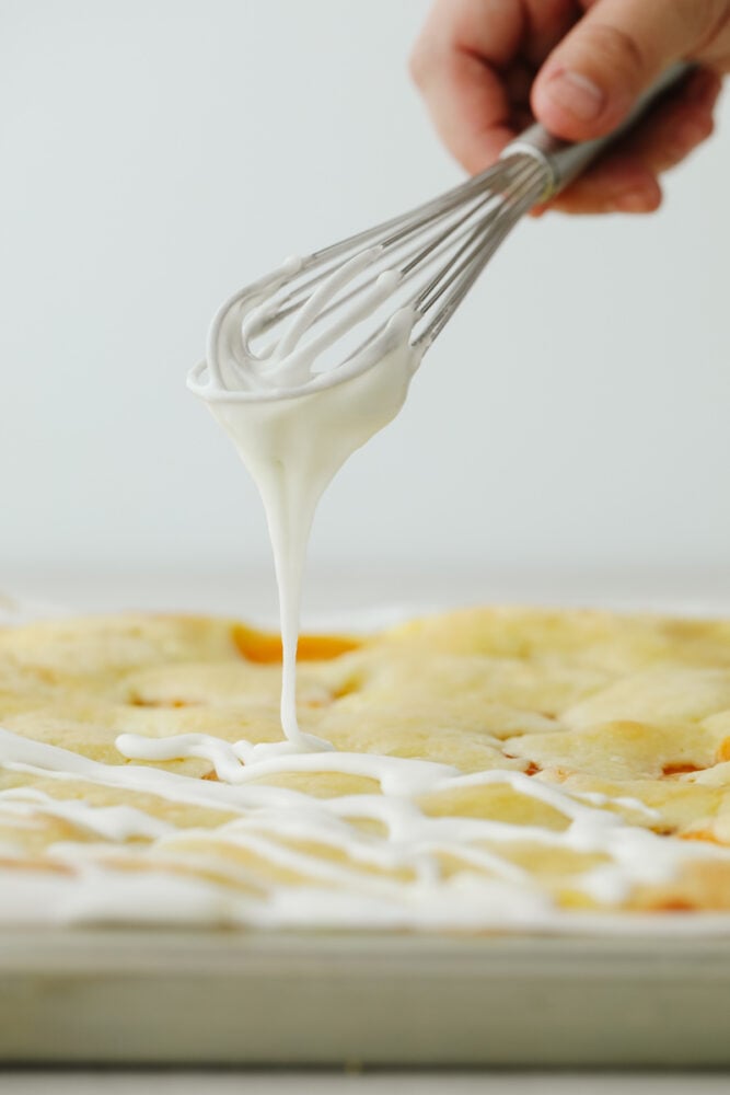 Frosting the tops of the peaches and pie bars. 