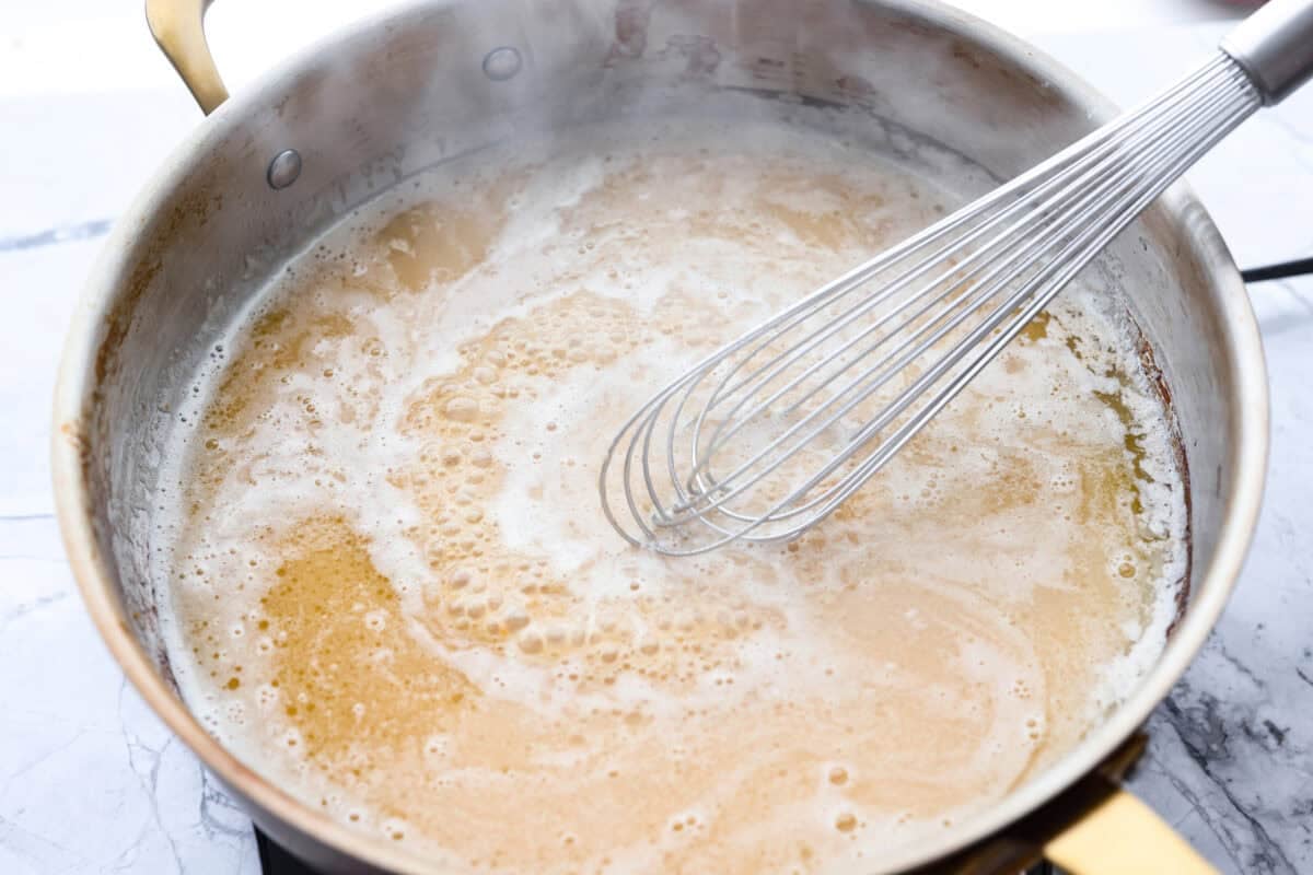 Miso and pasta water added to the skillet with butter and garlic. 
