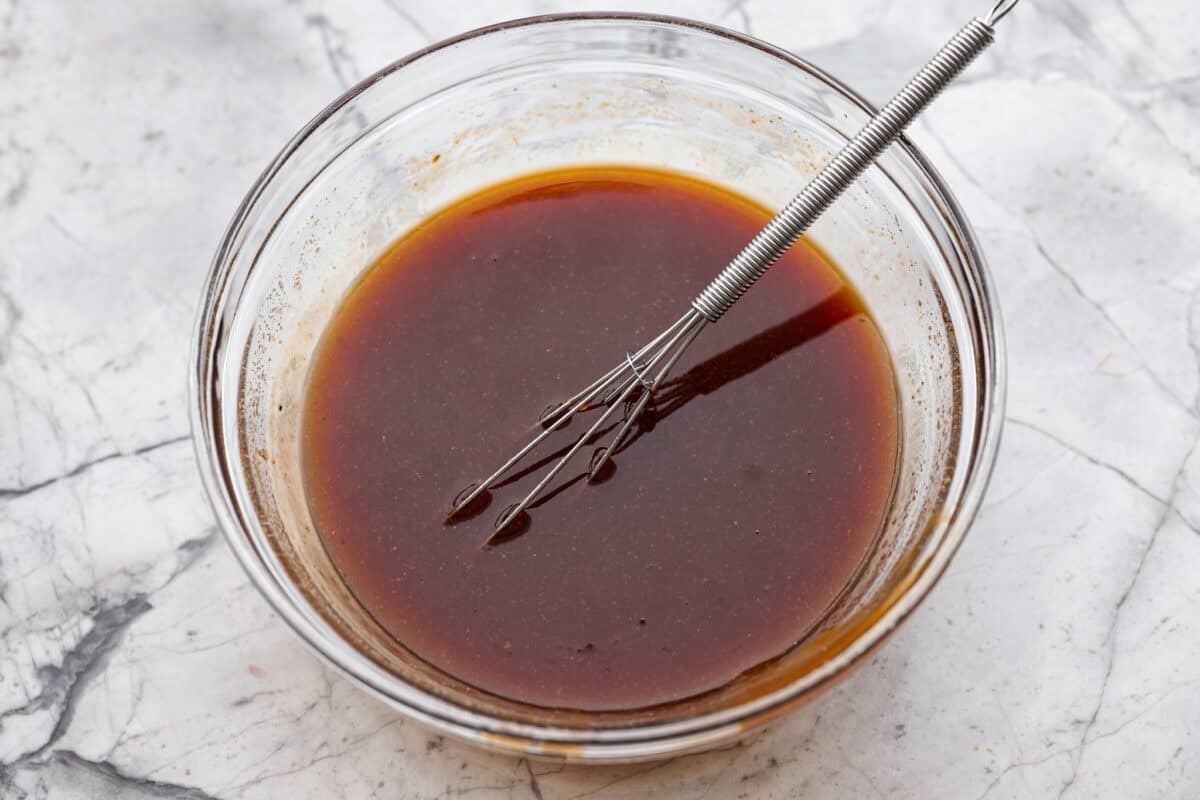 Slow cooker Aloha chicken sauce ingredients whisked together in a bowl.