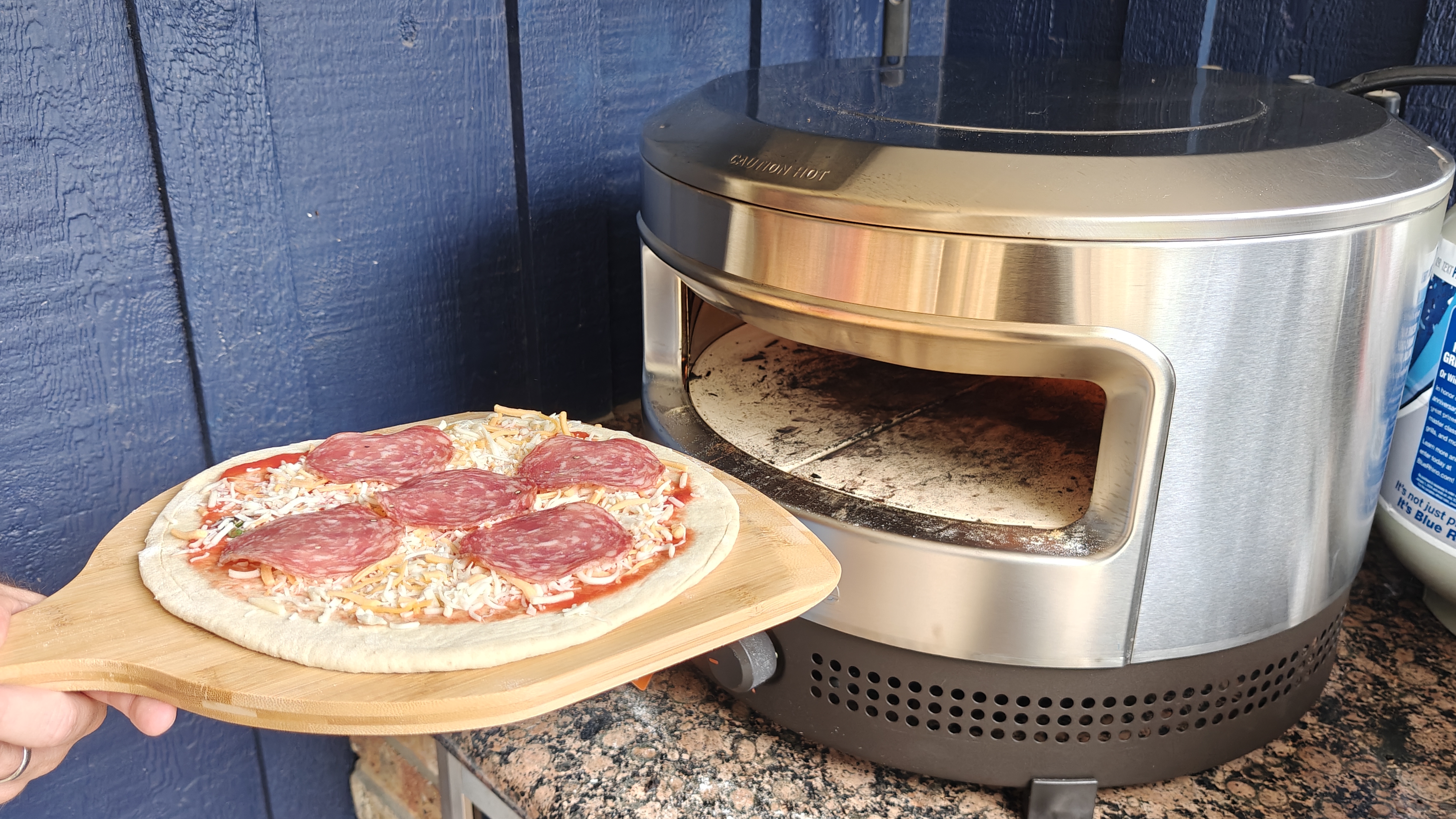 pepperoni pizza next to the solo stove