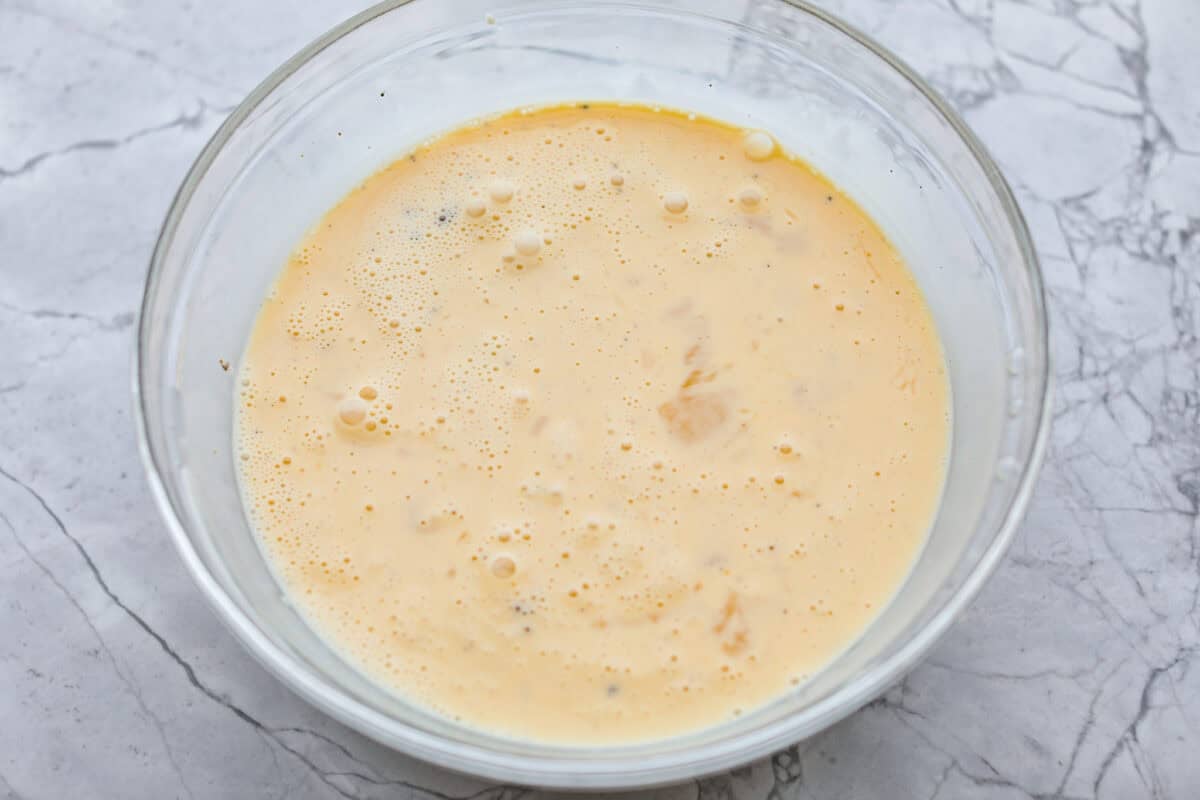 Egg mixture all whisked together in a bowl. 