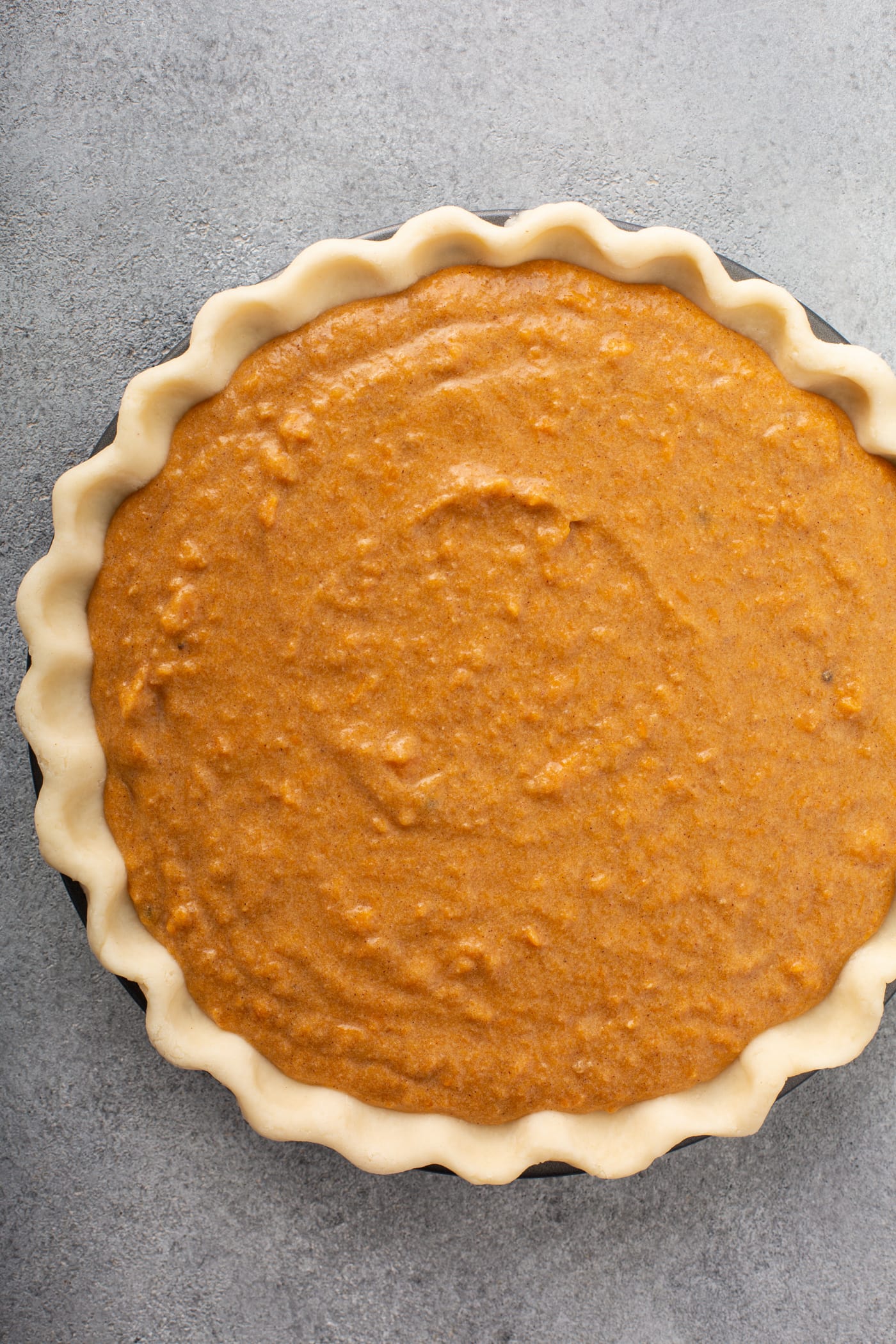 A photo of an unbaked sweet potato pie.