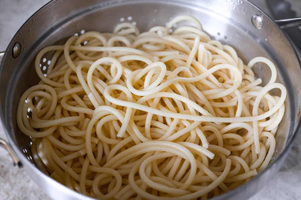 Colander with cooked noodles in it. 