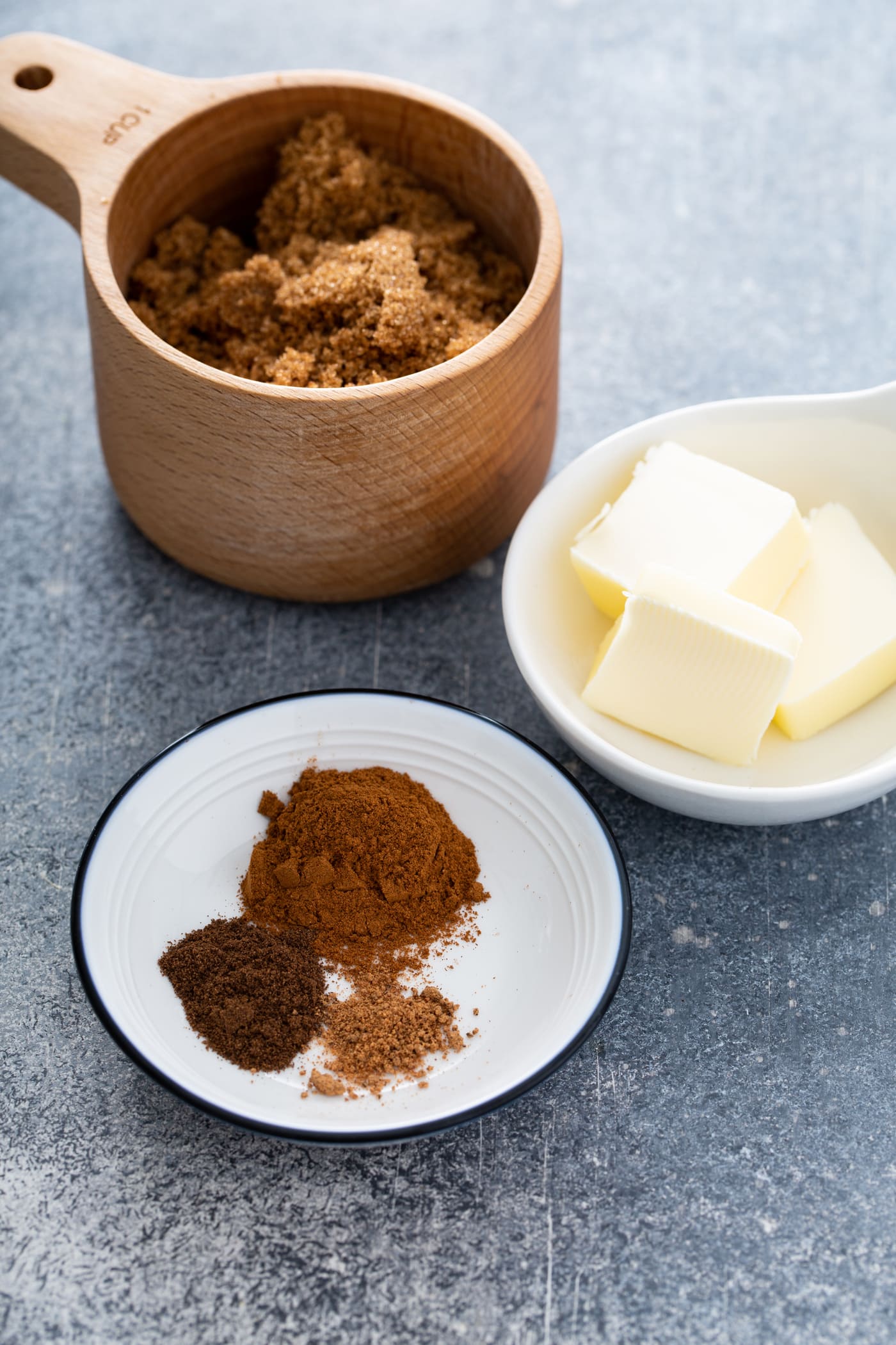 Containers of spices, butter and cinnamon.