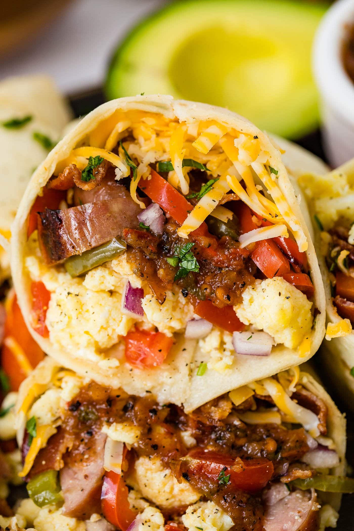 An apple chicken sausage burrito stuffed full of sausage, eggs, peppers, and cheese.