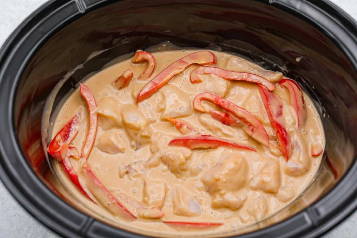 Sauce added to the peppers and chicken in the slow cooker. 