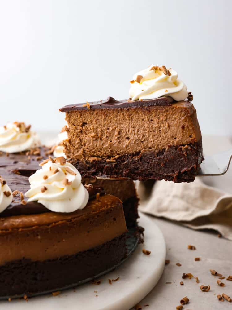 A slice of cheesecake being served with a cake spatula.