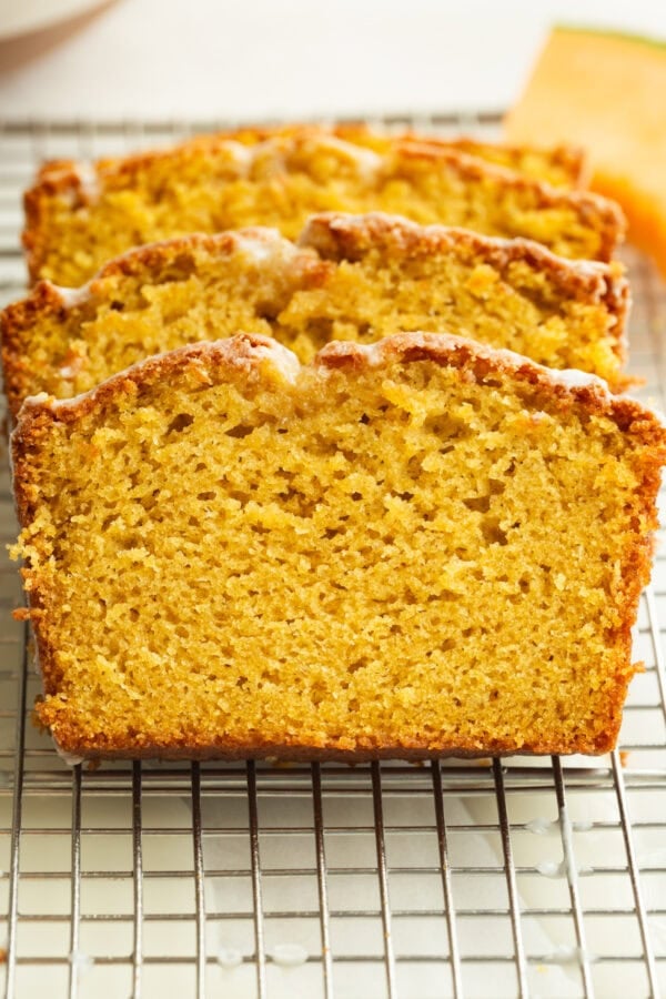 several slices of moist cantaloupe bread topped with a white glaze