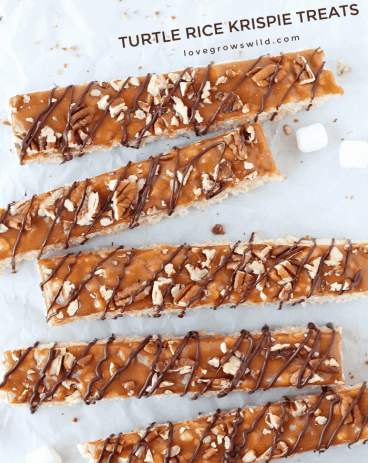 Classic rice krispie treats with a delicious turtle topping of creamy caramel, crunchy pecans, and a decadent chocolate drizzle! | Love Grows Wild for TheRecipeCritic.com