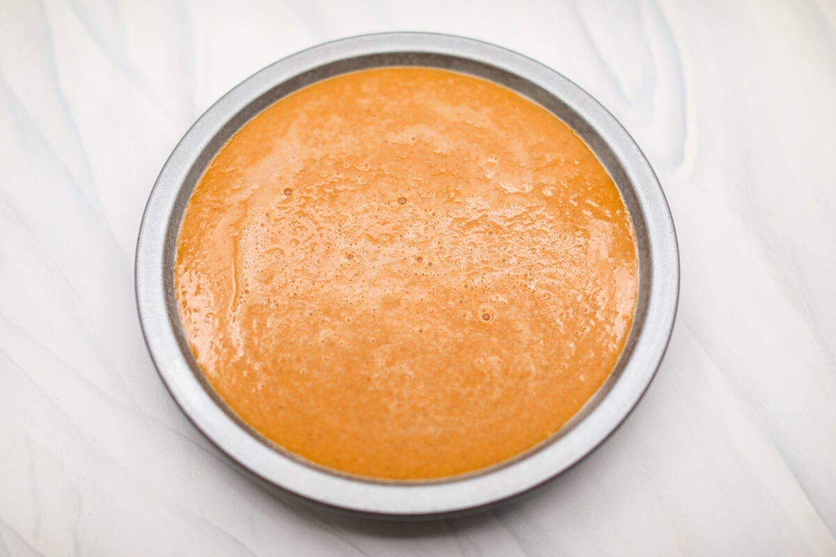Overhead shot of pie pan with whisked ingredients inside it.
