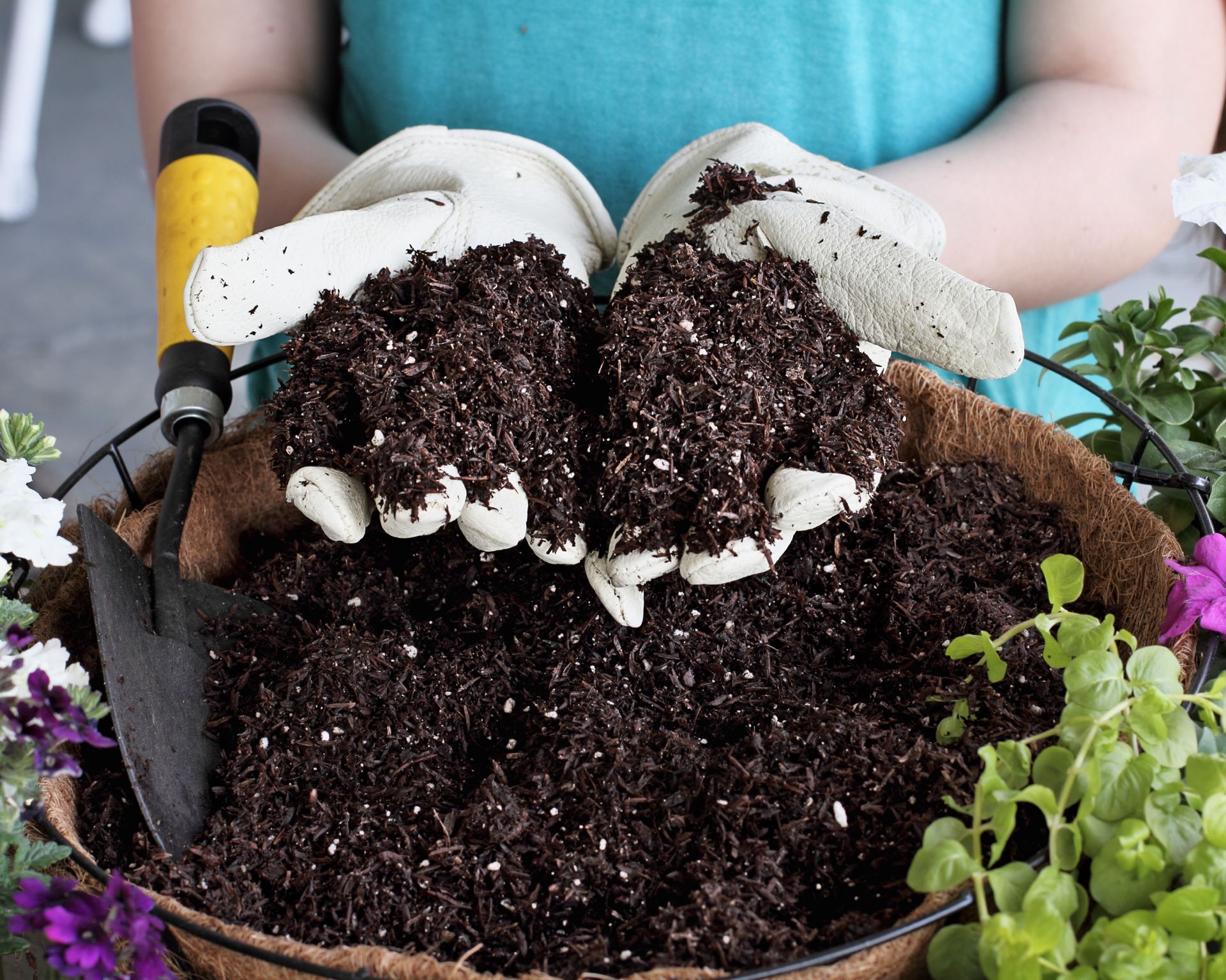 woman filling basket with soil