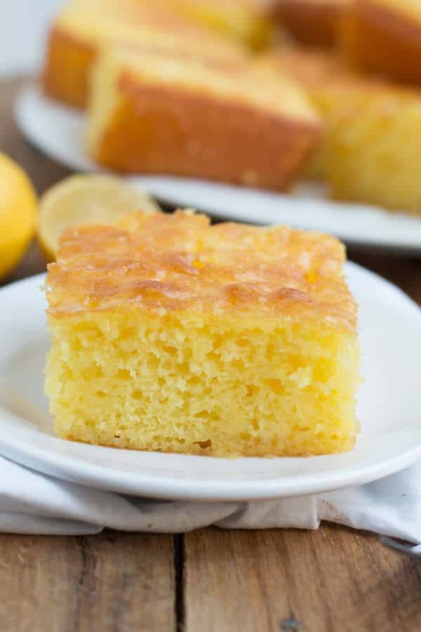 Slice of Lemon Jello Cake on a white plate.