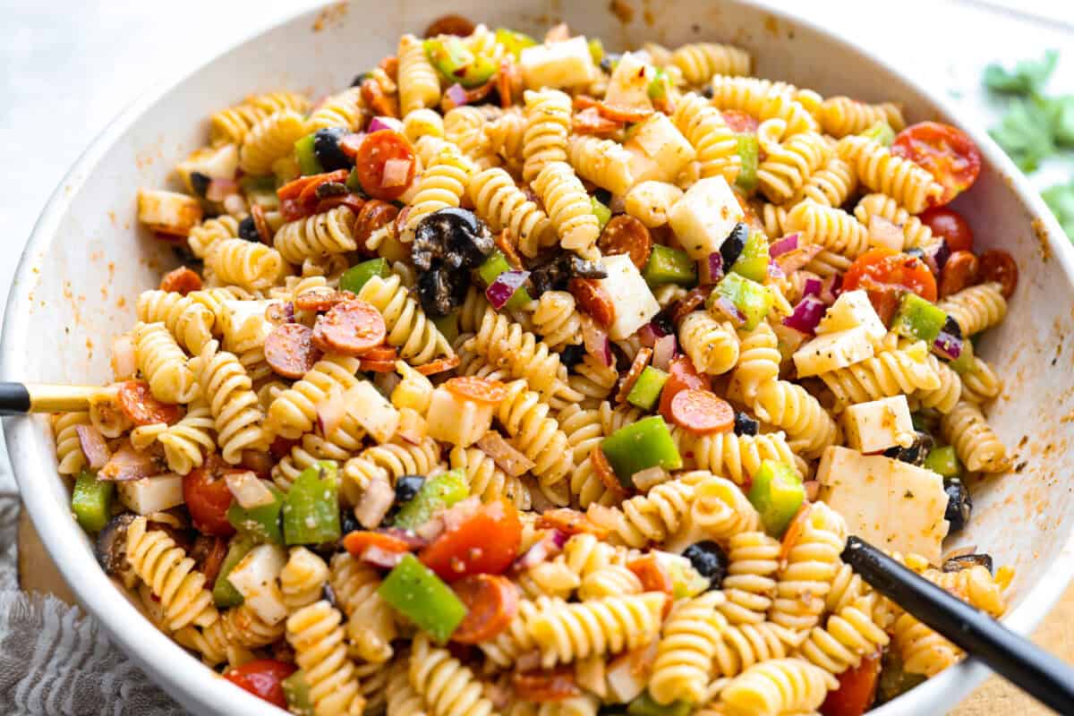 Pasta, veggies, meats and cheese all mixed together with the dressing. 