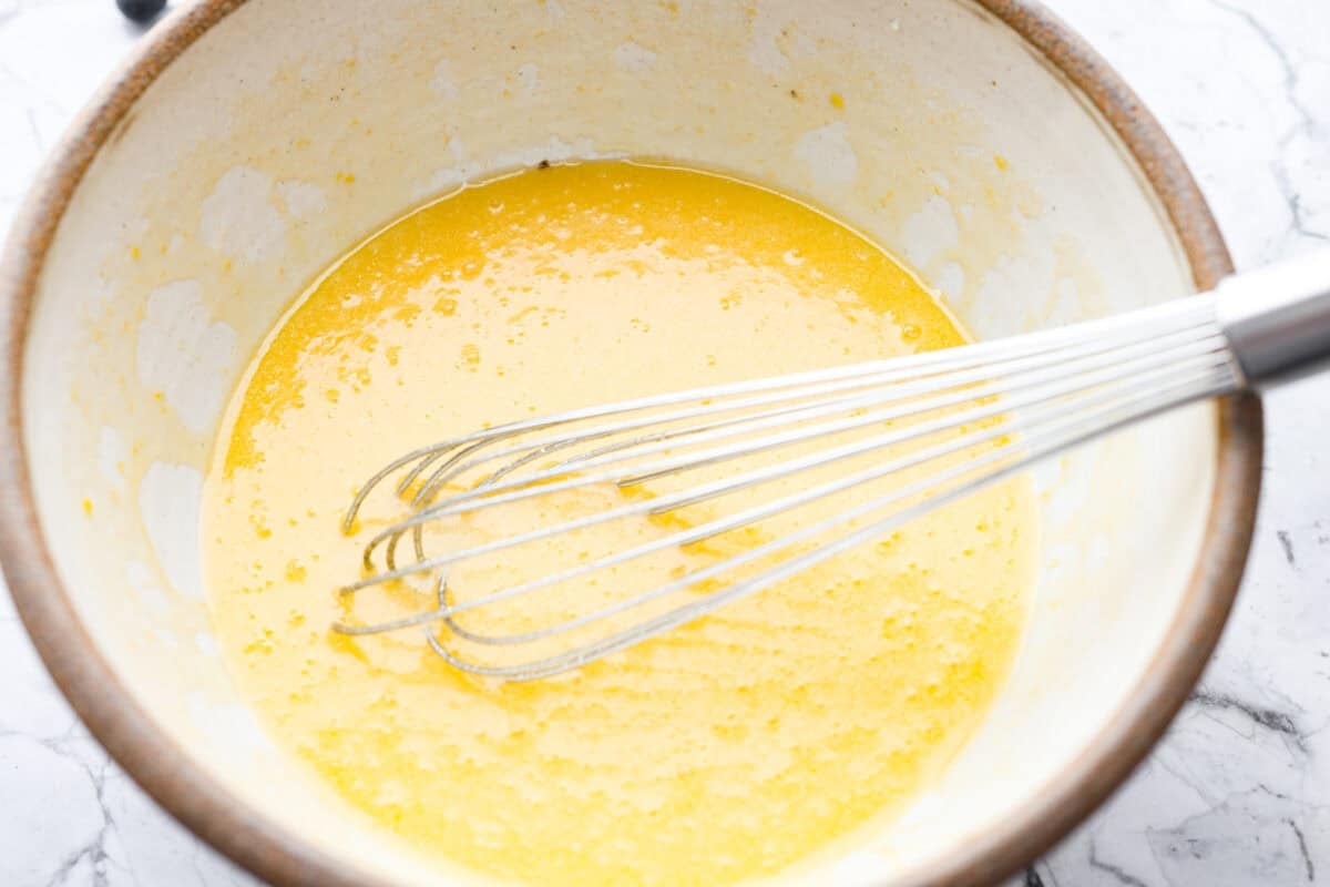 Bowl of melted butter, sugar and eggs whisked together. 