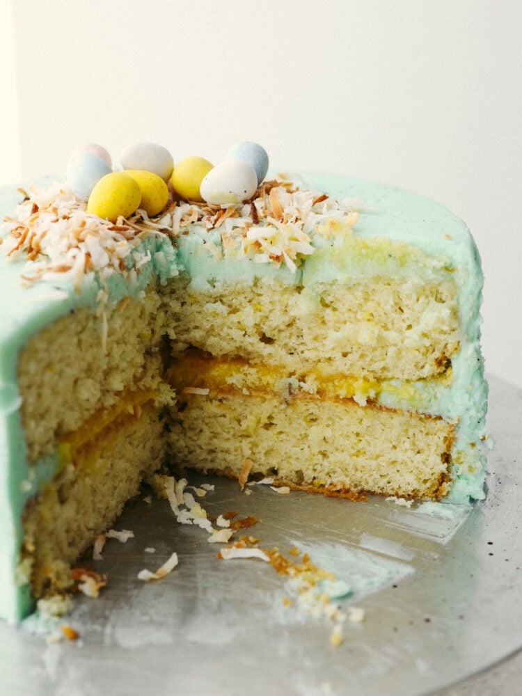 A side view of a cake with slices taken out. You can see the inside including the layer of lemon curd! 