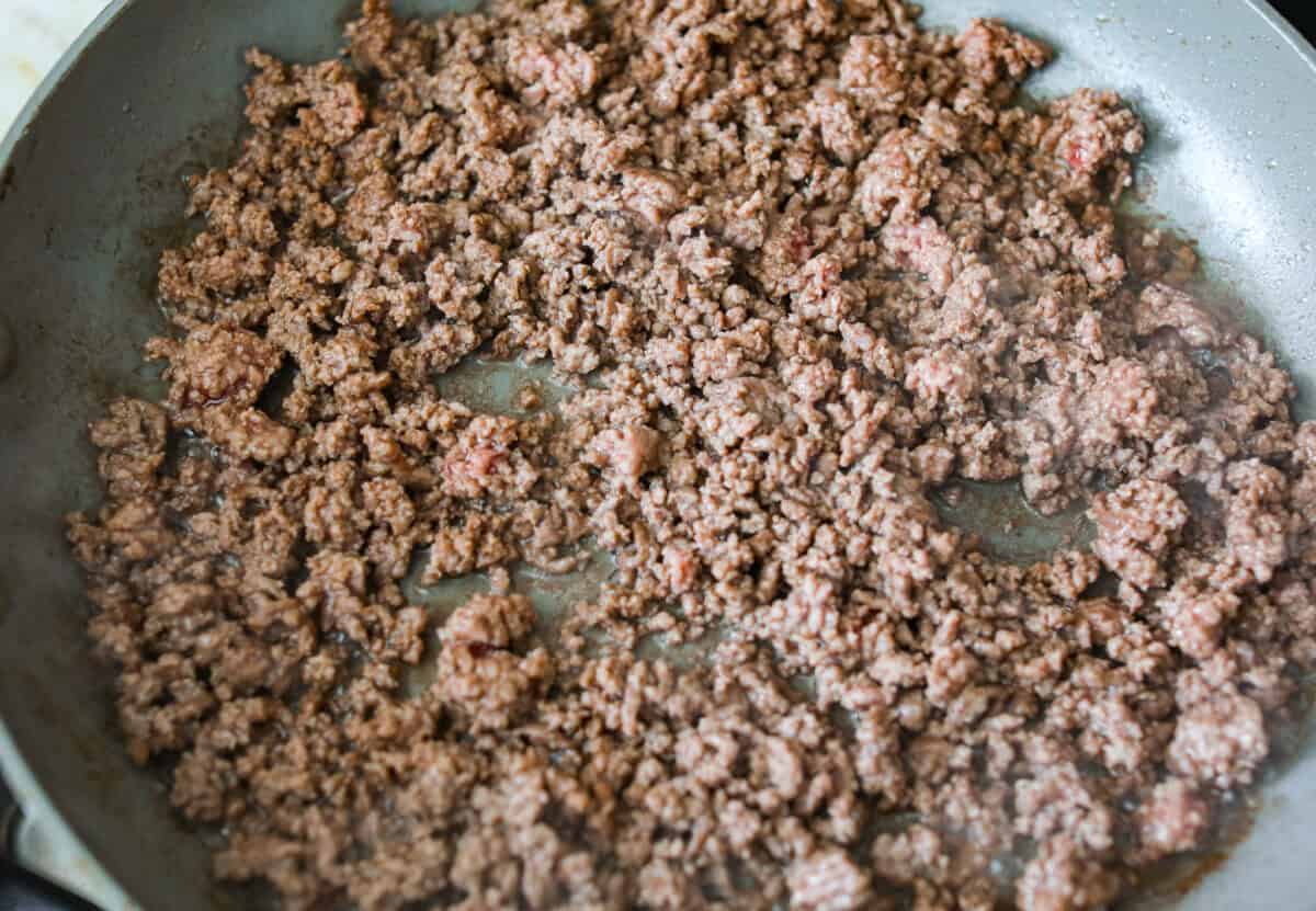 Ground beef cooking in a skillet. 
