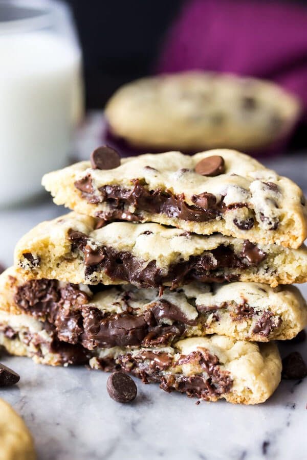 These fudge filled chocolate chip cookies are simple, classic chocolate chip cookies with a decadent chocolate fudge filling on the inside! These surprise-inside cookies are sure to be a new favorite! ohsweetbasil.com