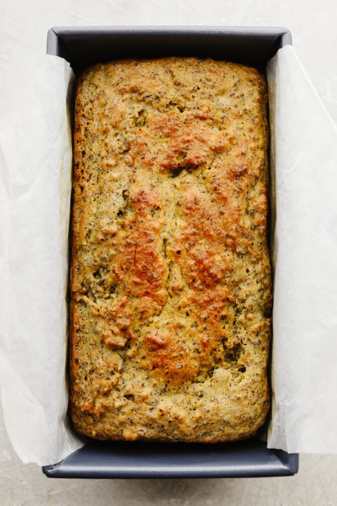 Keto bread cooked in a bread pan with parchment paper. 