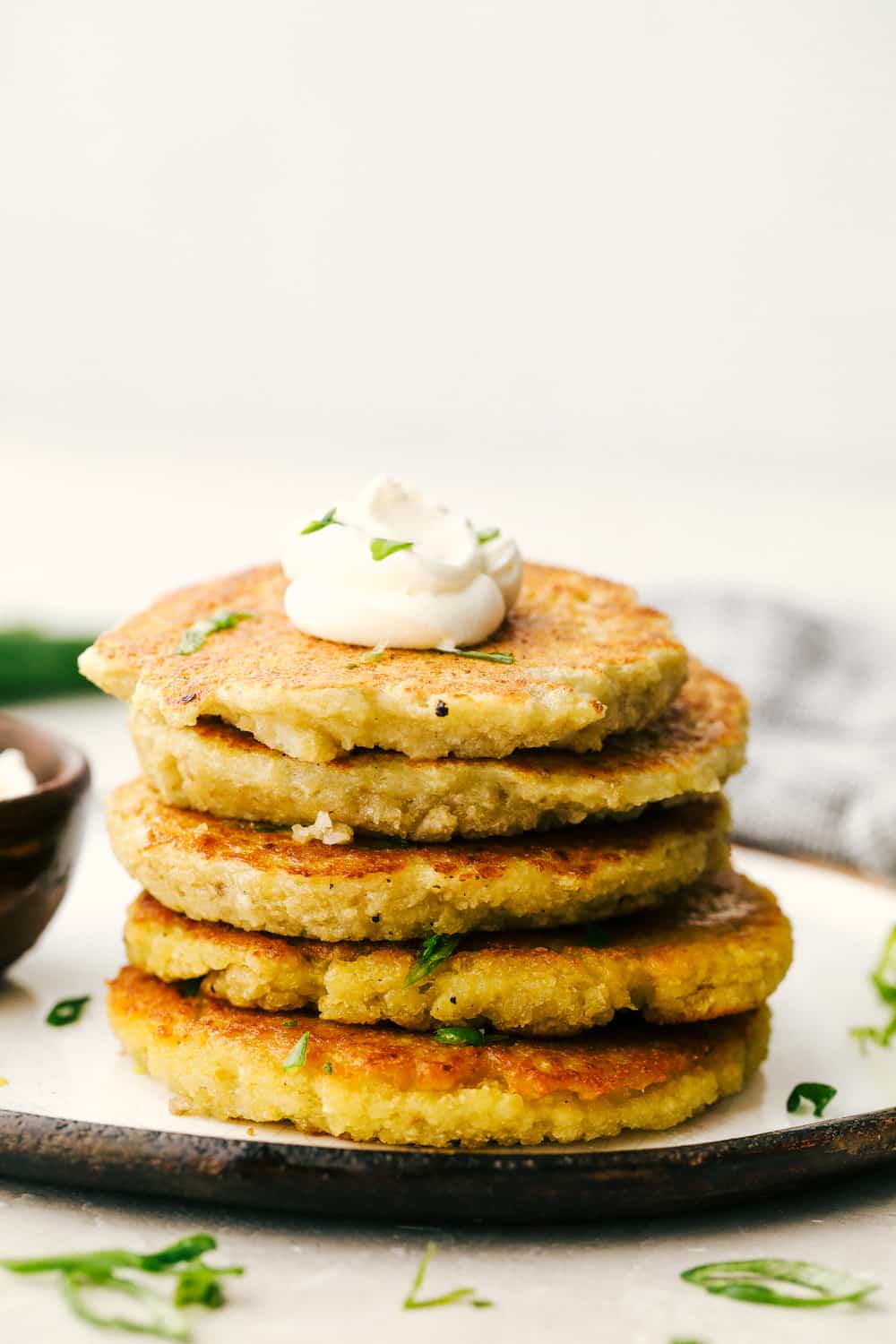 Potato pancakes stacked with a dollop of sour cream. 