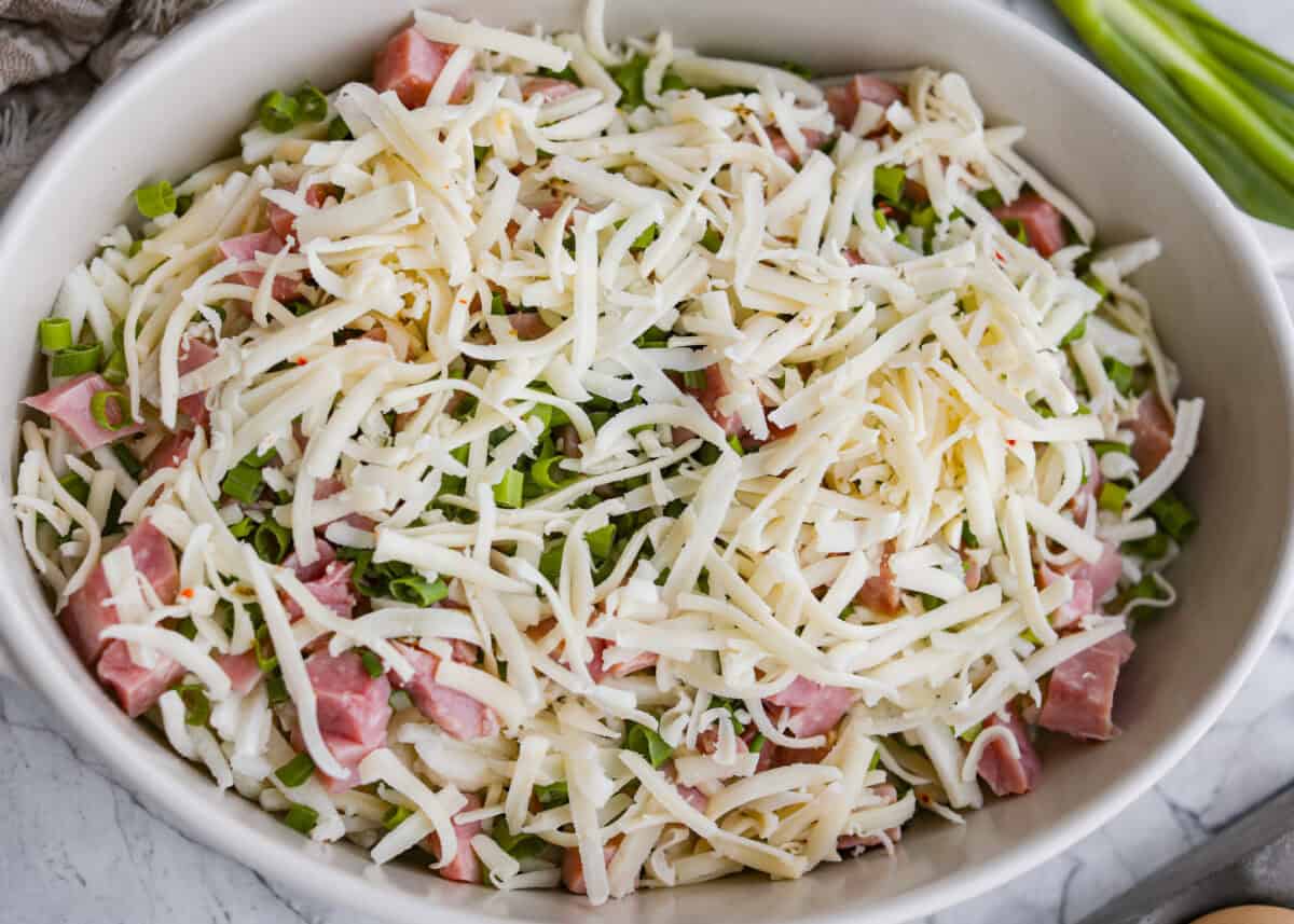 Ham, green onions, and cheese added to the baking dish. 