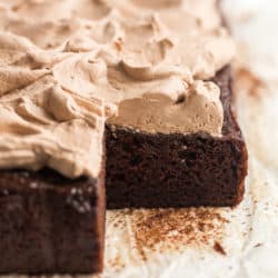 whole chocolate zucchini cake with a piece cut out
