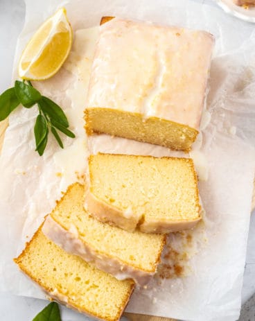 Birdseye view of a glazed cake on a sheet of baking paper.