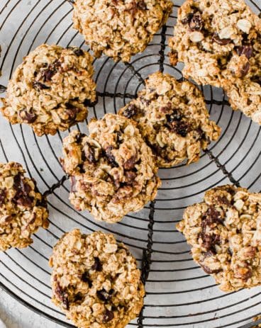 Oatmeal cookies on a round wire rack.