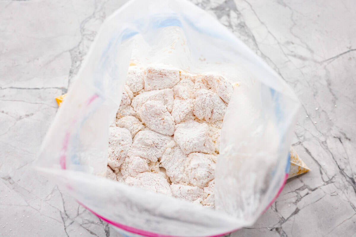 Bag of seasoned chicken covered in corn starch. 