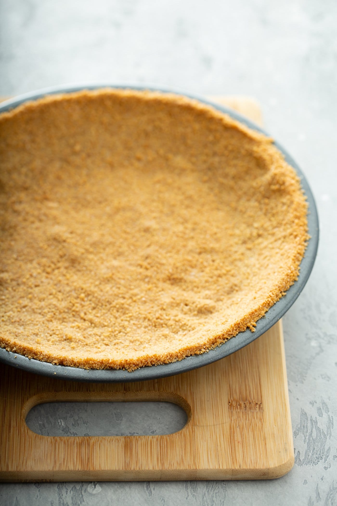 A graham cracker crust in a pie pan.