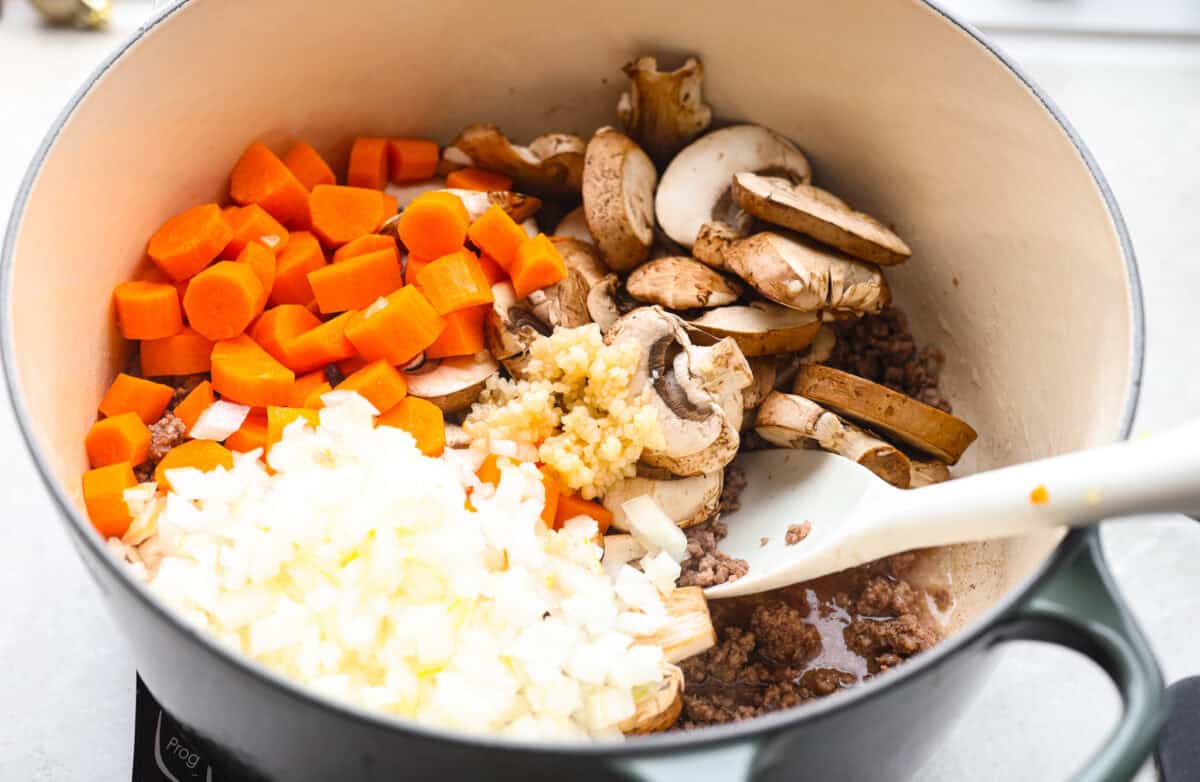 Carrots, mushrooms, onion and garlic added to the cooked ground beef. 