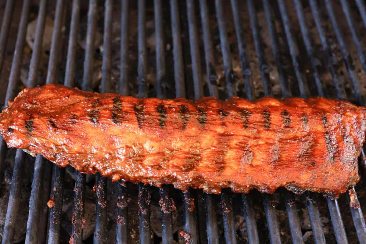 Grilled bbq ribs covered in bbq sauce. 